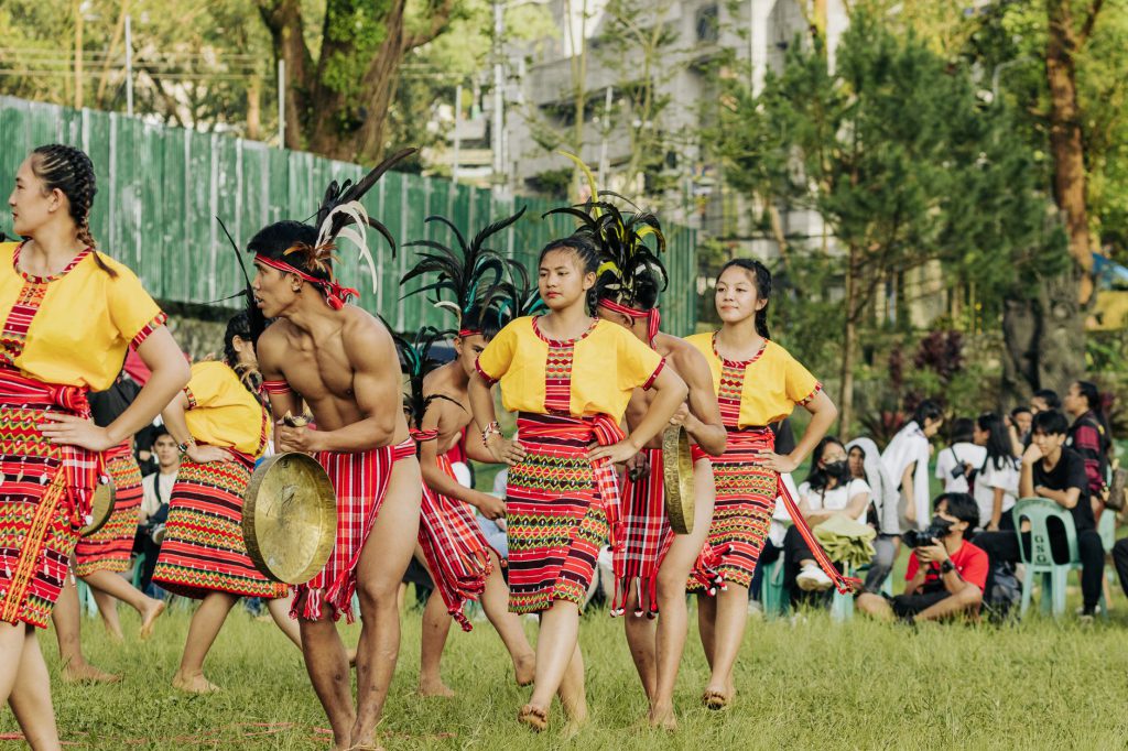 Vibrant outdoor performance showcasing Filipino traditional dance in colorful folk costumes.