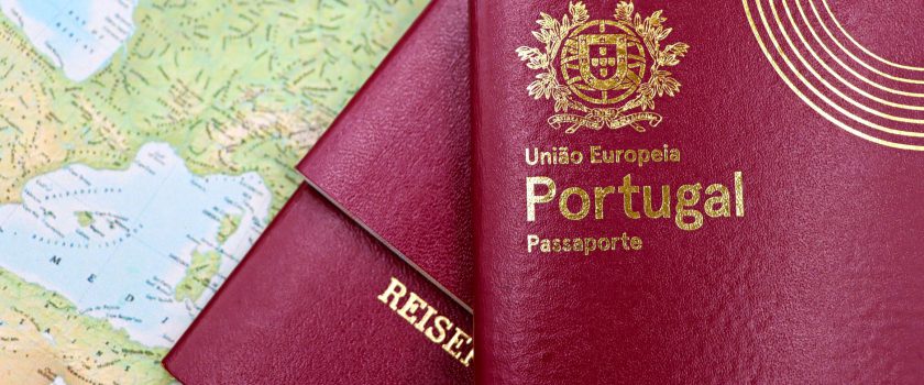 Close-up of Portuguese and Austrian passports lying on a map of Europe, symbolizing travel and mobility.