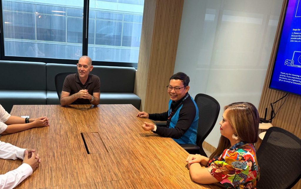 Andy Schachtel at the head of a conference table with four colleagues
