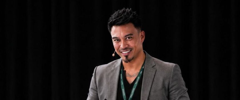 Marco Perrott, CEO of LYRIQ, smiling as he speaks on stage in a grey blazer