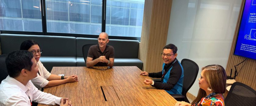 Andy Schachtel at the head of a conference table with four Sourcefit colleagues